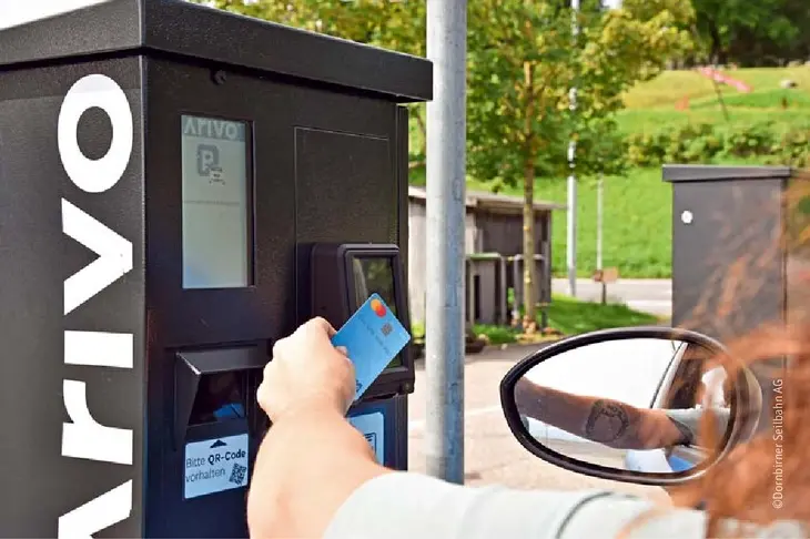 Driver using a contactless card at an Arivo parking terminal